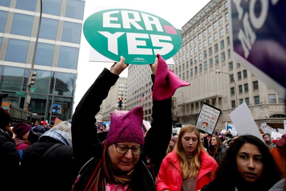 A demonstrator holds a sign supporting the Equal Rights Amendment in Washington DC on 19 January.