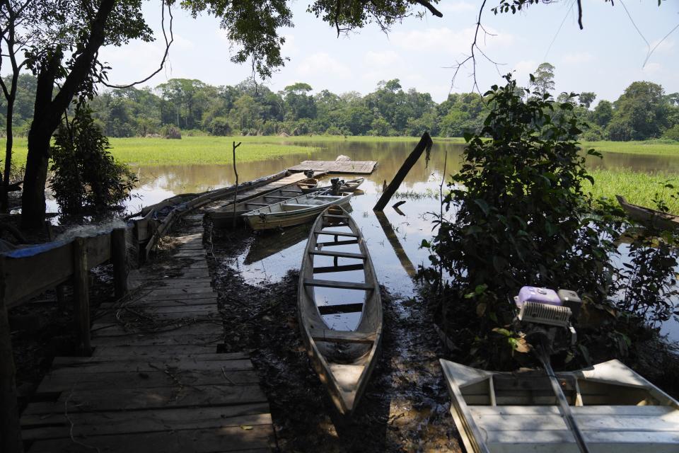 Boats sit at a dock at Lago Serrado community, near Carauari, Brazil, Thursday, Sept. 1, 2022. A Brazilian non-profit has created a new model for land ownership that welcomes both local people and scientists to collaborate in preserving the Amazon.(AP Photo/Jorge Saenz)