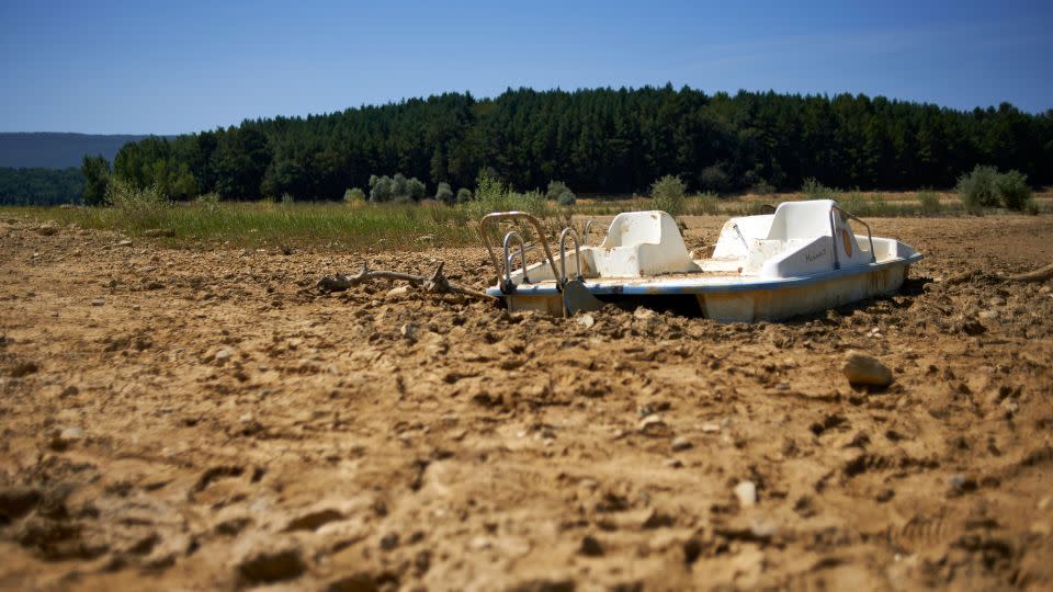 A paddleboat lies in the mud of the Montbel's lakebed, on August 18, 2023. Montbel is well below its normal level due to an unprecedented drought. - Alain Pitton/NurPhoto/Shutterstock
