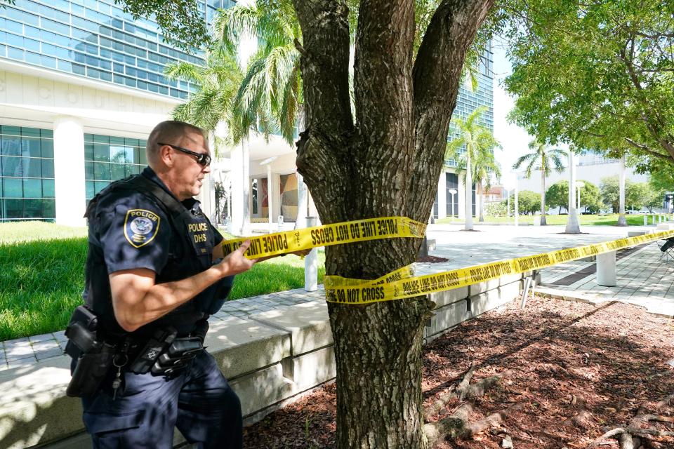 A Federal Protective Service Police officer cordons off an area outside the Wilkie D. Ferguson Jr. U.S. Courthouse, Monday, June 12, 2023, in Miami. Former President Donald Trump is set to appear at the federal court Tuesday, on dozens of felony charges accusing him of illegally hoarding classified information. (AP Photo/Wilfredo Lee)