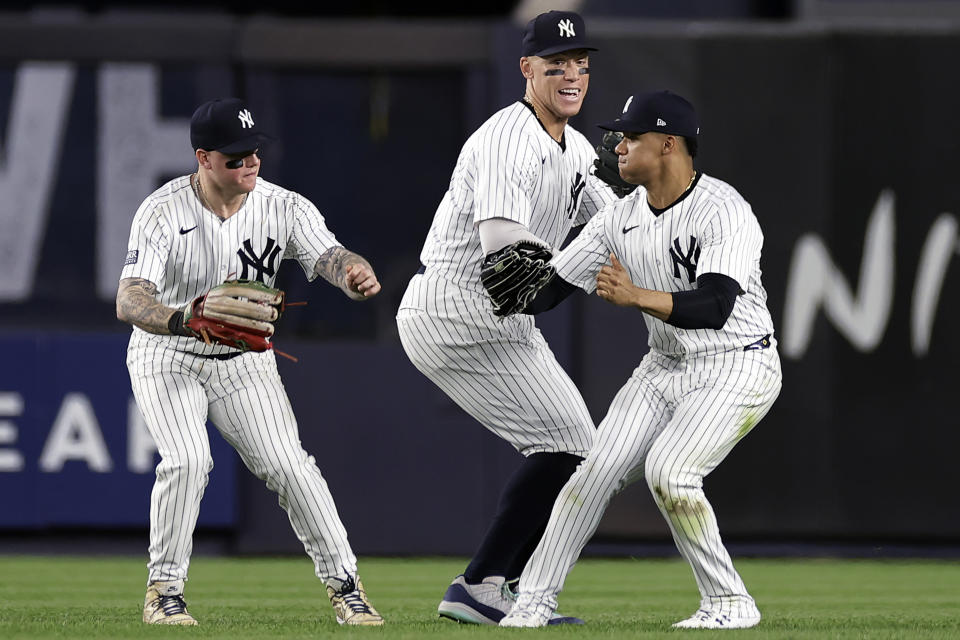 New York Yankees' Aaron Judge, center, Juan Soto and Alex Verdugo, left, celebrate after the Yankees defeated the Houston Astros in a baseball game Wednesday, May 8, 2024, in New York. (AP Photo/Adam Hunger)