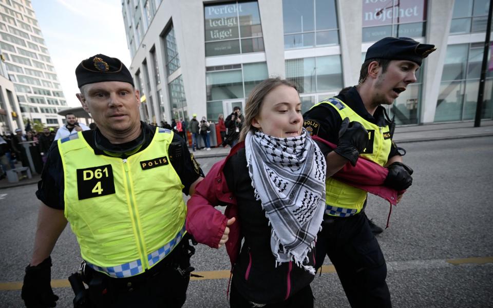 Climate activist Greta Thunberg is removed by police outside Malmo Arena