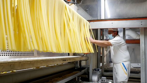 PHOTO: A worker at the Italian pasta maker De Cecco's factory prepares pasta in Fara San Martino, Italy, November 29, 2021. (Remo Casilli/Reuters, FILE)