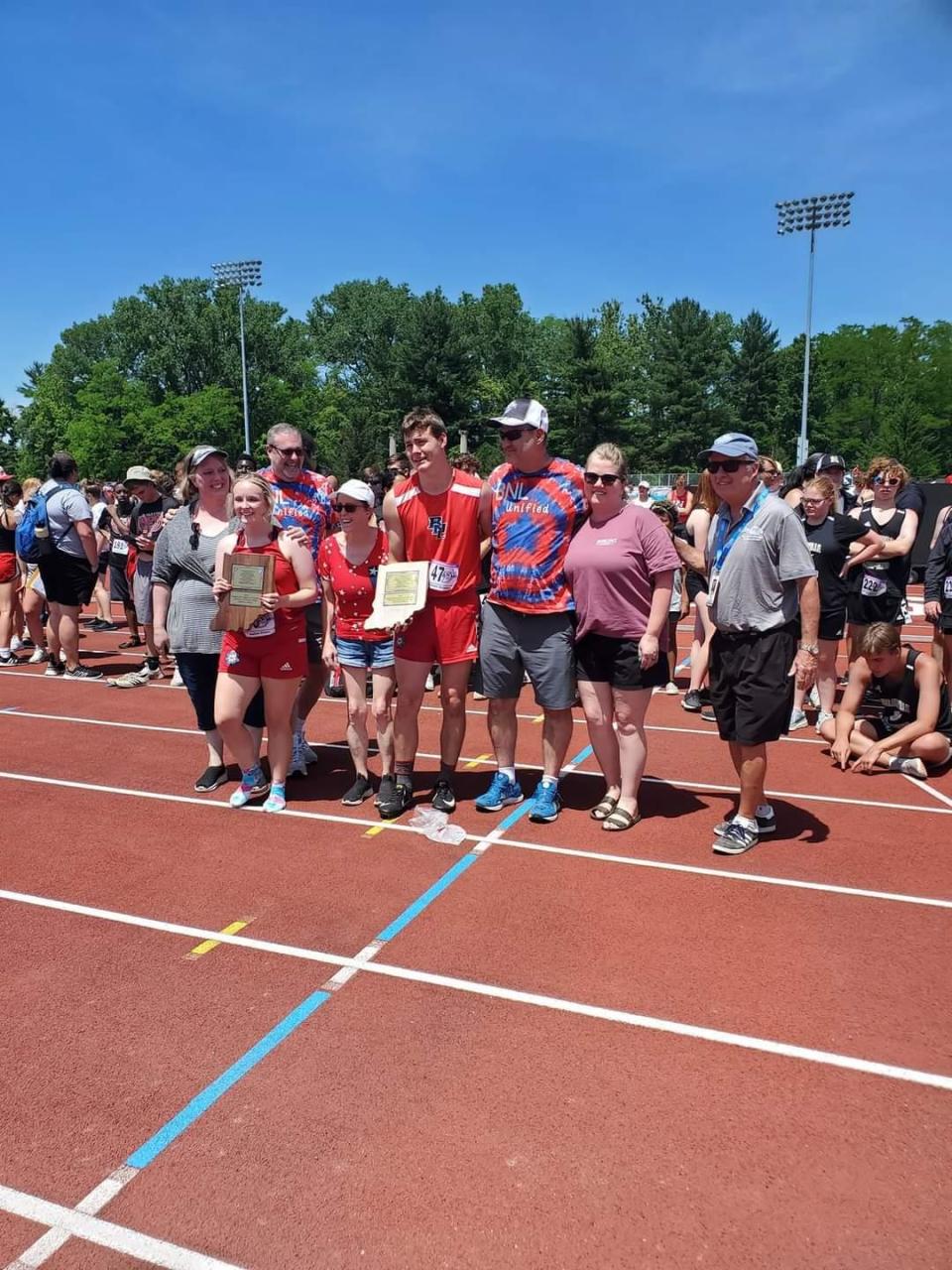 BNL seniors Jesselyn Fisher and Tanner Robbins are surrounded by their families as they receive the 2022 Mental Attitude Awards at Satuday's Unified Track & Field State Finals in Bloomington.