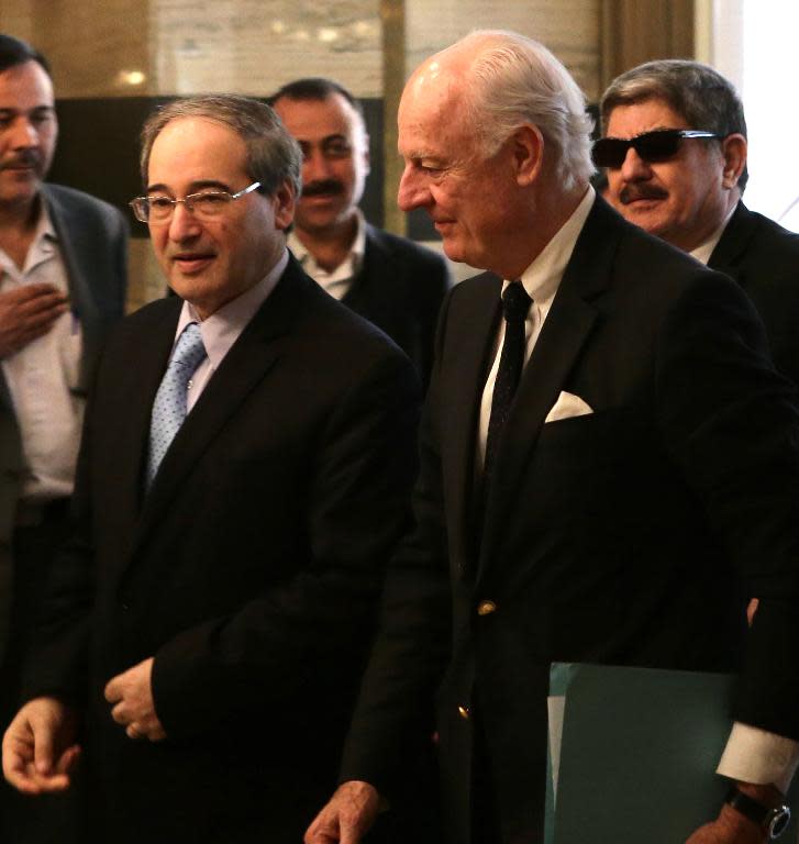 Syrian Deputy Foreign Minister Faisal Moqdad (L) meets with United Nations special envoy for Syria Staffan de Mistura in Damascus on February 28, 2015