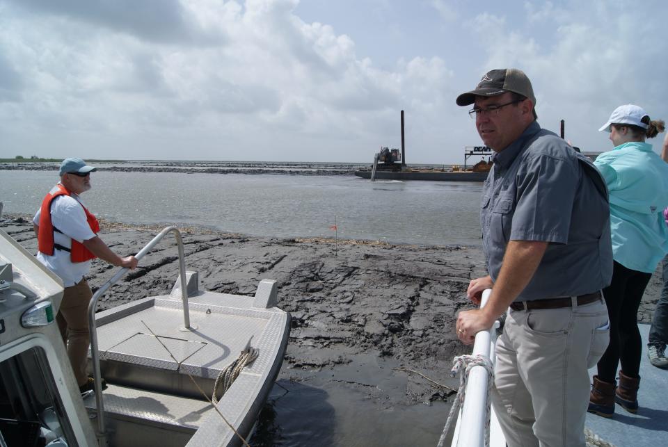 Discussing the work Tuesday at the East Raccourci Bay terrace project are, left, Greg Grandy, deputy director with the Louisiana Coastal Protection and Restoration Authority, and Bob Dew, director of development for Ducks Unlimited.