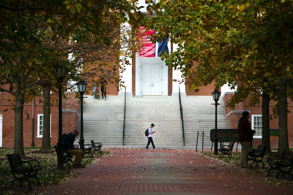 Students hang around Old College near Main Street on the UD campus. College enrollment is down nationally, 2.4 million fewer students than in fall 2011, but University of Delaware has managed to increase their enrollment.