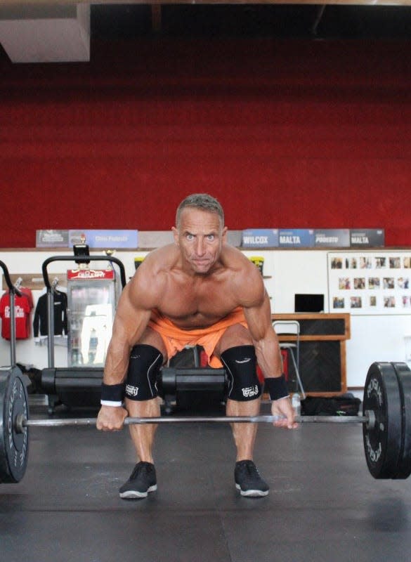 Podesto gets ready to perform a dead lift. Weightlifting is one of many events in CrossFit.