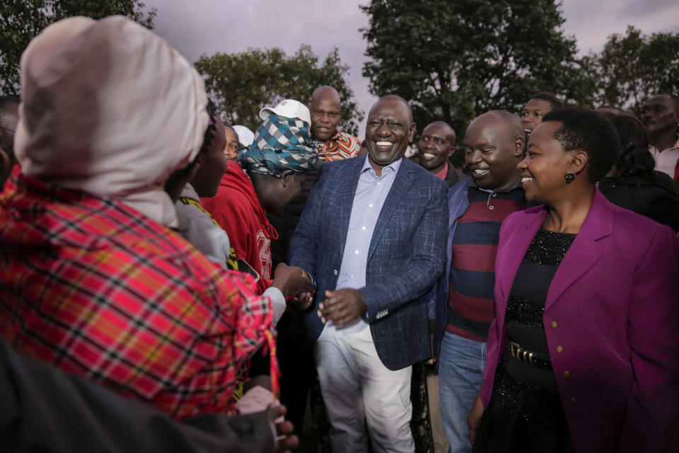 FILE - Deputy President and presidential candidate William Ruto, center, greets supporters after casting his vote in Kenya's general election in Sugoi, 50 kms (35 miles) north west of Eldoret, Kenya, Tuesday Aug. 9, 2022. Kenya's electoral commission chairman has declared Deputy President William Ruto the winner of the close presidential election over five-time contender Raila Odinga, a triumph for the man who shook up politics by appealing to struggling Kenyans on economic terms and not on traditional ethnic ones. (AP Photo/Brian Inganga, File)