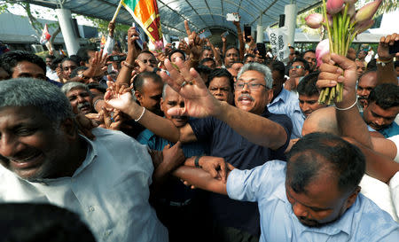 Sri Lanka's former defense secretary Gotabaya Rajapaksa greets his supporters after his return from the United States, in Katunayake, Sri Lanka April 12, 2019. REUTERS/Dinuka Liyanawatte