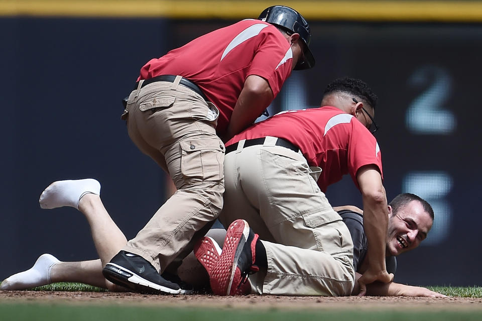 Security guards tackle a fan who ran onto the field during the second inning of a game between the Milwaukee Brewers and the San Francisco Giants at Miller Park on June 8, 2017 in Milwaukee, Wisconsin. (Photo by Stacy Revere/Getty Images)