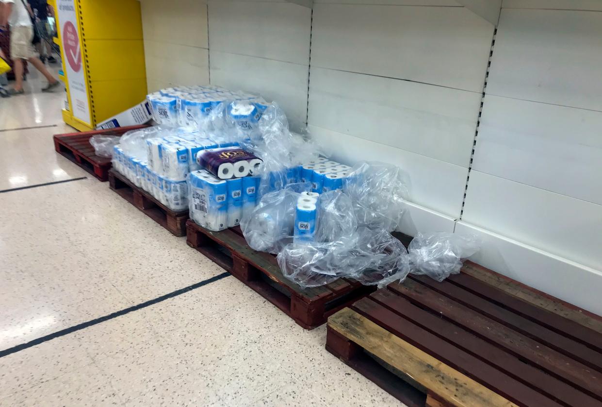 Depleted stocks and empty pallets in the toilet roll aisle at the Portsmouth North Harbour Tesco (PA)