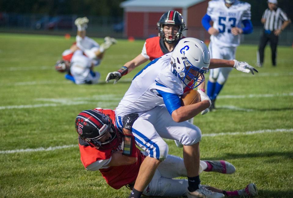 Crestline's Brandon Hiles is brought down by Bucyrus' Mason Gebhardt.