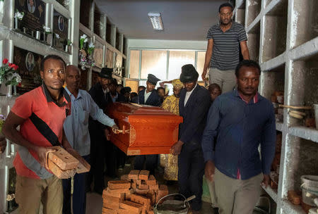 Workers carry a coffin of a passenger of the Ethiopian Airlines Flight ET 302 plane crash, at the wall vault cemetery of Balewold Church, part of the Holy Trinity Cathedral Church in Addis Ababa, Ethiopia March 17, 2019. REUTERS/Maheder Haileselassie