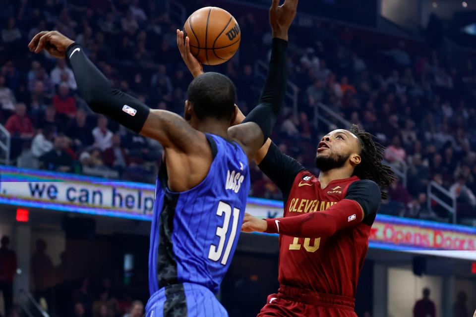 Cleveland Cavaliers guard Darius Garland (10) shoots against Orlando Magic guard Terrence Ross (31) during the first half of an NBA basketball game Friday, Dec. 2, 2022, in Cleveland. (AP Photo/Ron Schwane)