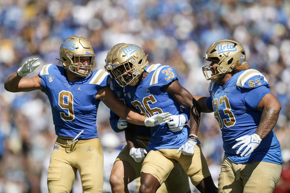 Alex Johnson of the UCLA Bruins celebrates with teammates after intercepting the ball against Washington State. (Meg Oliphant/Getty Images)