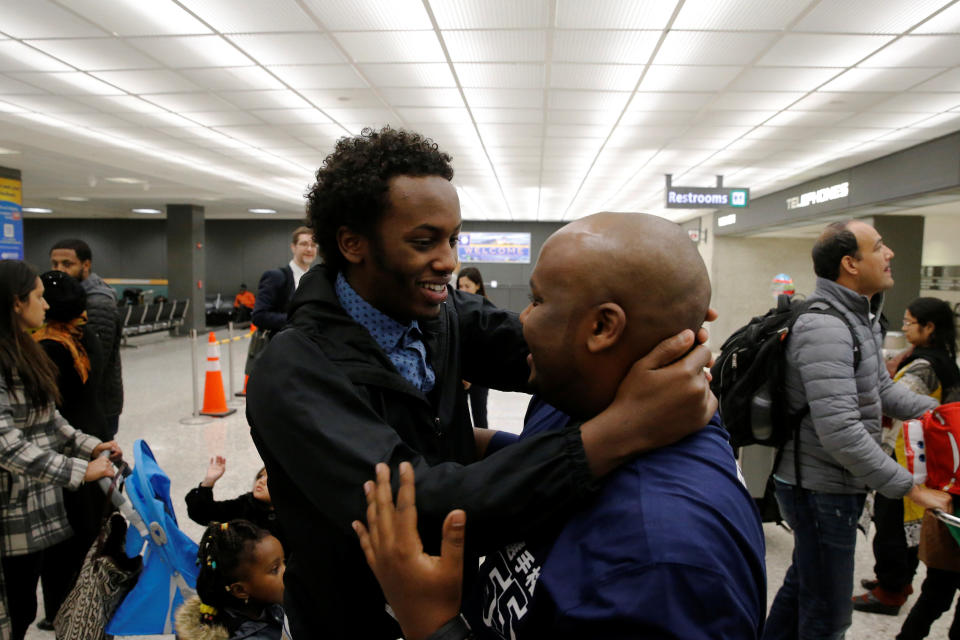 Mustafa Aidid, right, a Somali national who was delayed entry into the U.S. because of the Jan. 27 travel ban, is reunited with his brother Taha Aidid, left, at Washington Dulles International Airport in Chantilly, Virginia on Feb. 6, 2017.