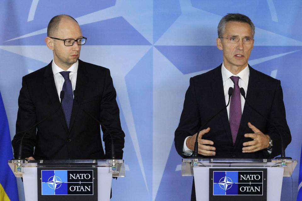 NATO Secretary General Jens Stoltenberg (R) gestures during a joint news conference with Ukraine's Prime Minister Arseny Yatseniuk after a meeting at NATO headquarters in Brussels December 15, 2014. REUTERS/Eric Vidal (BELGIUM - Tags: POLITICS CIVIL UNREST)