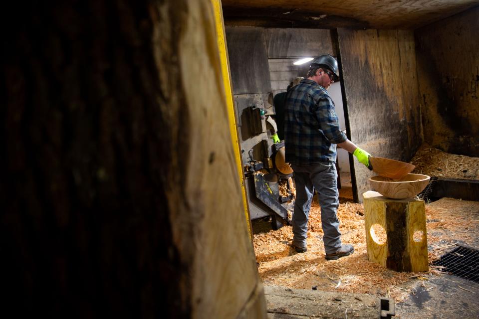 Mill workers prepare wood to be carved into bowls Thursday, March 2, 2023, at the Holland Bowl Mill.