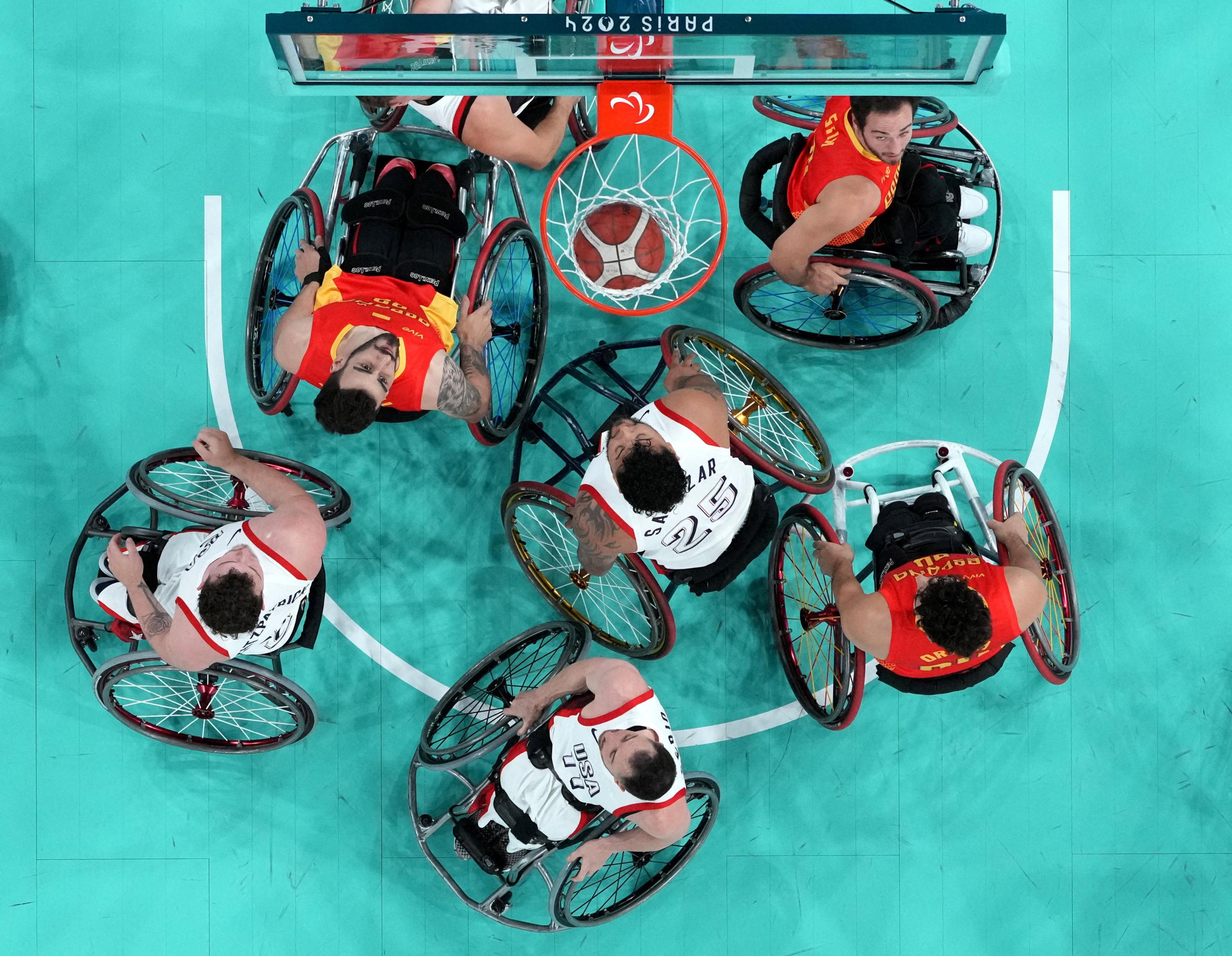 Wheelchair participants on a basketball court.