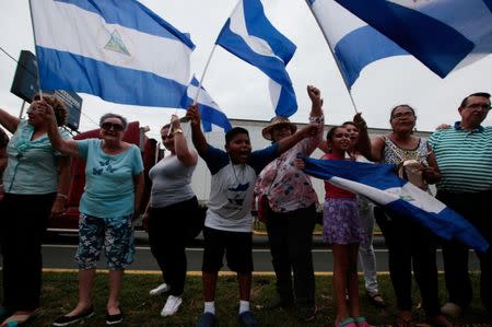 Anti-government protesters hold national flags during a caravan of car and motorcycles to demand an end to violence in Ticuantepe, Nicaragua July 15, 2018.REUTERS/Oswaldo Rivas