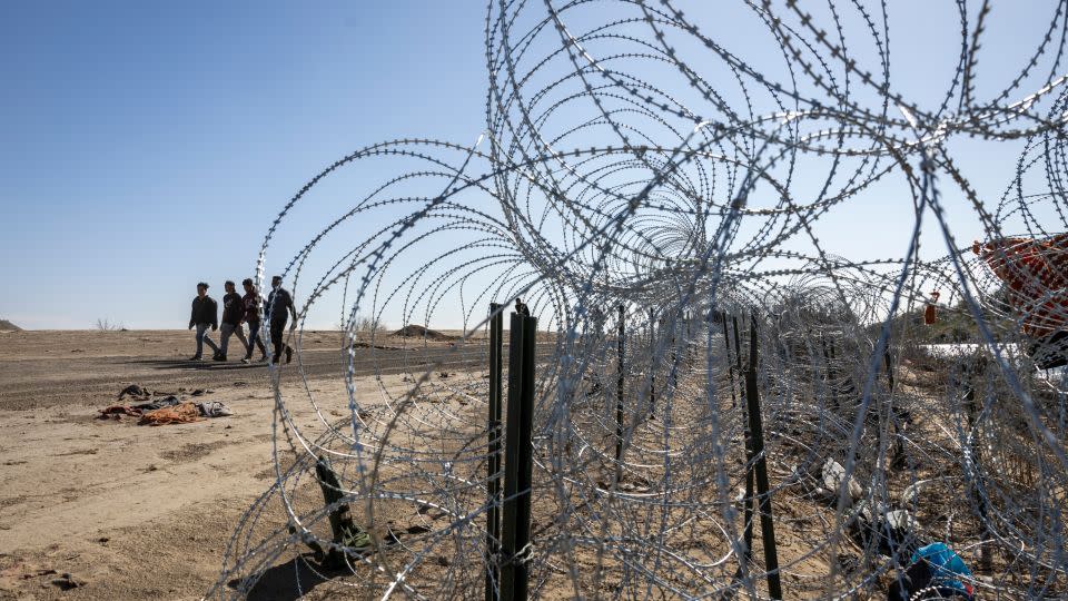 Immigrants from Venezuela walk towards a US Border Patrol transit center after crossing the Rio Grande into the United States on January 8, 2024, in Eagle Pass, Texas. - John Moore/Getty Images