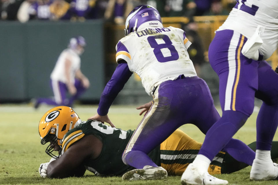 Green Bay Packers defensive tackle Kenny Clark recovers a fumble by Minnesota Vikings quarterback Kirk Cousins (8) during the second half of an NFL football game, Sunday, Jan. 1, 2023, in Green Bay, Wis. (AP Photo/Morry Gash)