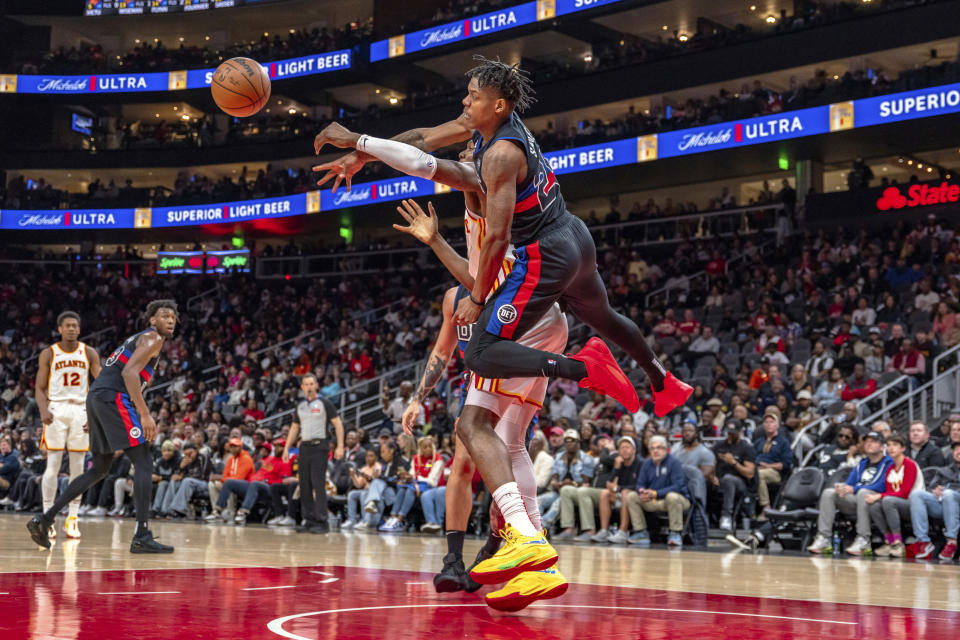Atlanta Hawks center Clint Capela (15) passes the ball guarded by Detroit Pistons guard Marcus Sasser (25) during the second half of an NBA basketball game, Wednesday, April 3, 2024, in Atlanta. (AP Photo/Jason Allen)