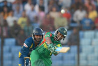 Bangladesh batsman Shakib Al Hasan (R) plays a shot as Sri Lankan wicket keeper Kumar Sangakkara looks on during the second T20 cricket match between Bangladesh and Sri Lanka at The Zahur Ahmed Chowdhury Stadium in Chittagong on February 14, 2014. AFP PHOTO/ Munir uz ZAMAN