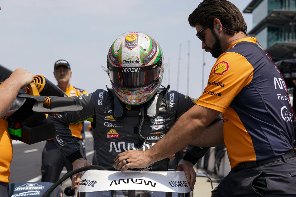 Pato O'Ward, of Mexico, climbs into his car during practice for the Indianapolis 500 auto race at Indianapolis Motor Speedway in Indianapolis, Friday, May 19, 2023. (AP Photo/Michael Conroy)