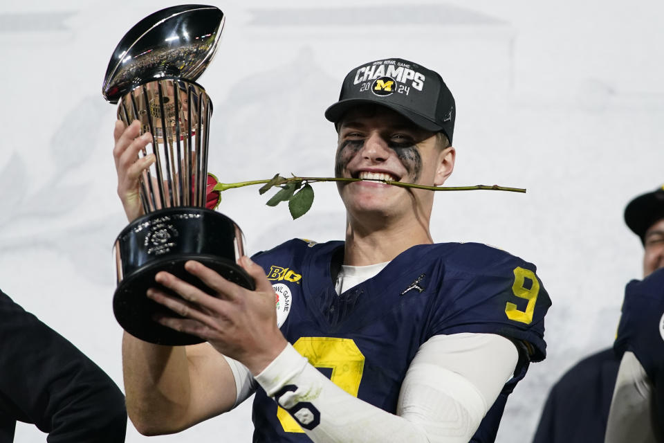 Michigan quarterback J.J. McCarthy (9) celebrates on the podium after a win over Alabama in the Rose Bowl CFP NCAA semifinal college football game Monday, Jan. 1, 2024, in Pasadena, Calif. (AP Photo/Ryan Sun)