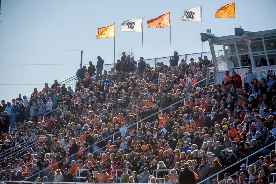 Flags fly in the breeze as a large crowd turns out to watch Washington battle East St. Louis in the Class 6A football state semifinals Saturday, Nov. 18, 2023 at Babcook Field in Washington.