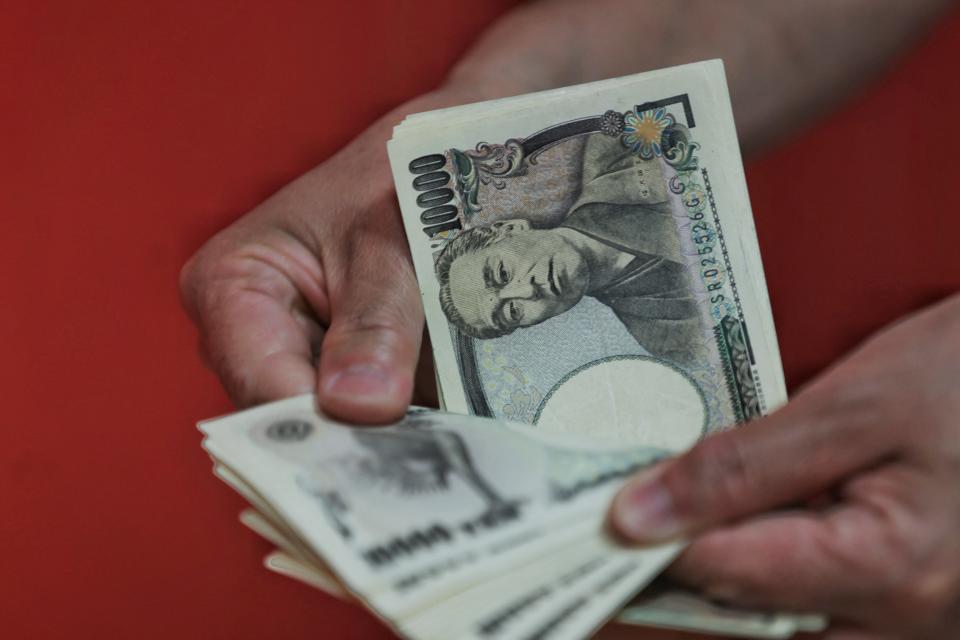 This photo illustration shows a person counting out Japanese 10,000 yen banknotes (75 USD) in Tokyo on June 8, 2022. - The dollar fetched 133.03 yen in Asian trade on June 8, its highest in two decades. (Photo by Behrouz MEHRI / AFP) (Photo by BEHROUZ MEHRI/AFP via Getty Images)