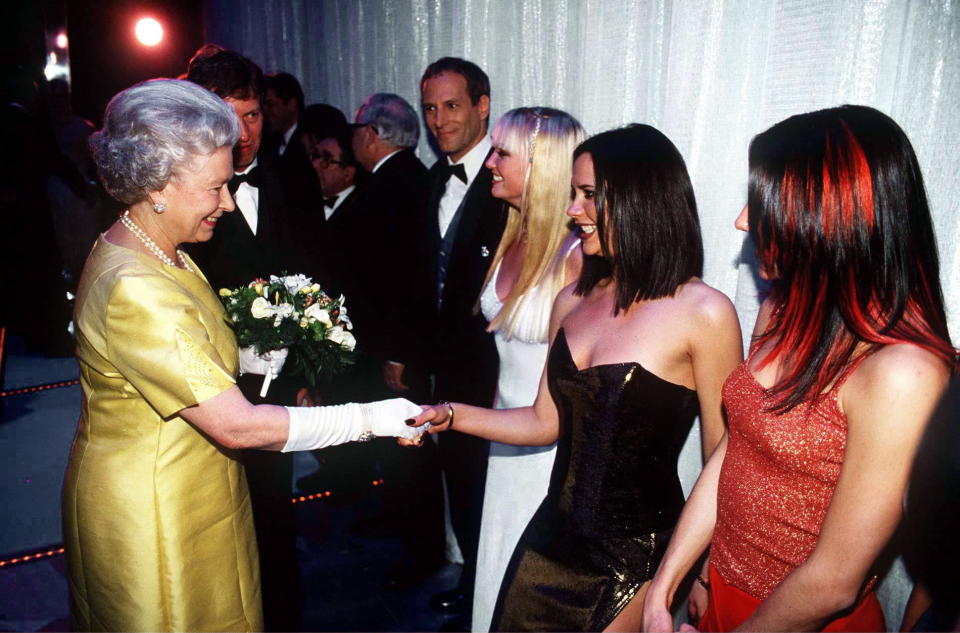 LONDON, UNITED KINGDOM - DECEMBER 01:  The Queen At The Royal Command Performance At The Victoria Palace Theatre On 1st December 1997 Shaking Hands With Pop Star Victoria Beckham (posh Spice) Of The Pop Band The Spice Girls.  (Photo by Tim Graham Picture Library/Getty Images)