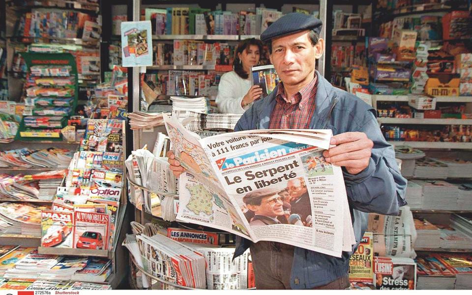 9 April 1997: Sobhraj enjoying reading about himself back in Paris after his release from jail in India - Shutterstock