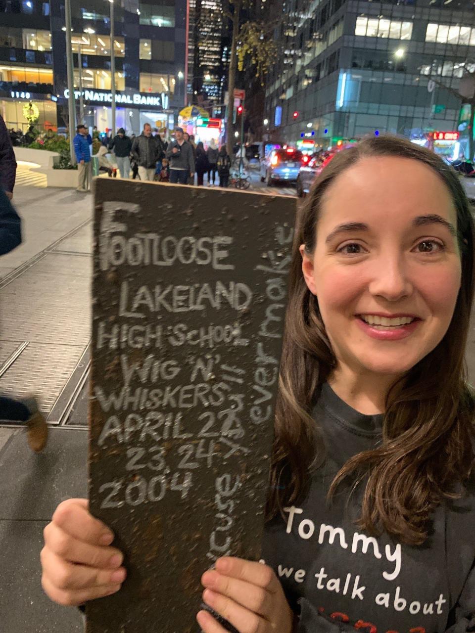 Ashley Wool, one of the stars of the Broadway musical "How to Dance in Ohio," outside the Belasco Theater on Nov. 30, 2023, with "Tressie," a keepsake from her high school theater days at Lakeland High School in Shrub Oak. The board came from the trestle bridge in Lakeland's 2004 production of "Footloose," a production that had a profound impact on Wool. The actress successfully petitioned to have a National High School Theater Day commemorated each April 24.