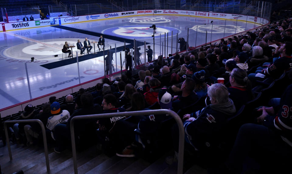 NHL Commissioner Gary Bettman, center left, and Deputy Commissioner Bill Daly, center right, along with Winnipeg Jets co-owner Mark Chipman, left, speak to season-ticket holders before an NHL hockey game between the St. Louis Blues and the Winnipeg Jets on Tuesday, Feb. 27, 2024, in Winnipeg, Manitoba. (Fred Greenslade/The Canadian Press via AP)