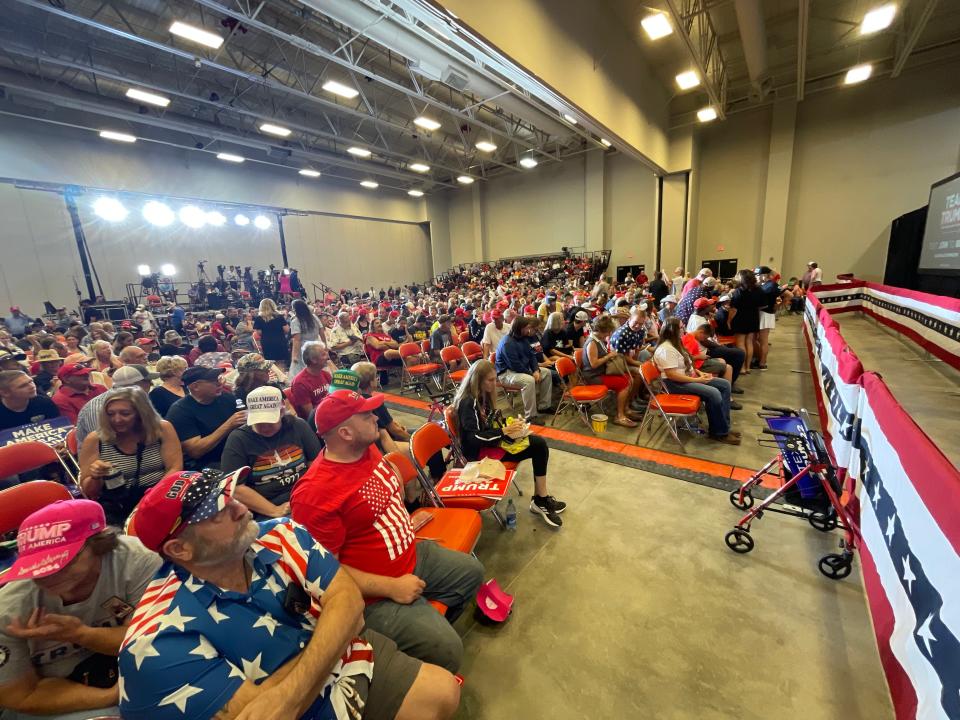 Iowans awaiting 2024 presidential candidate Donald Trump to appear at a campaign rally in Ottumwa, Iowa. Most of the people in the crowd wore Trump shirts, hats, and other regalia.