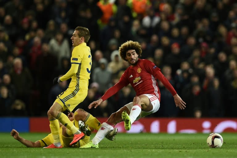 Rostov's Rforward Aleksandr Bukharov (2L) fouls Manchester United's midfielder Marouane Fellaini (R) during the UEFA Europa League round of 16 second-leg football match between Manchester United and FC Rostov on March 16, 2017