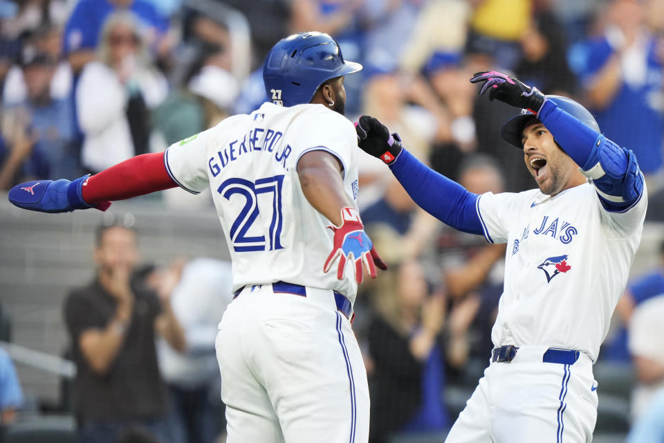 Toronto Blue Jays' George Springer, right, celebrates his three-run home run against the New York Yankees with Vladimir Guerrero Jr. (27) during the first inning of a baseball game in Toronto on Thursday, June 27, 2024. (Frank Gunn/The Canadian Press via AP)