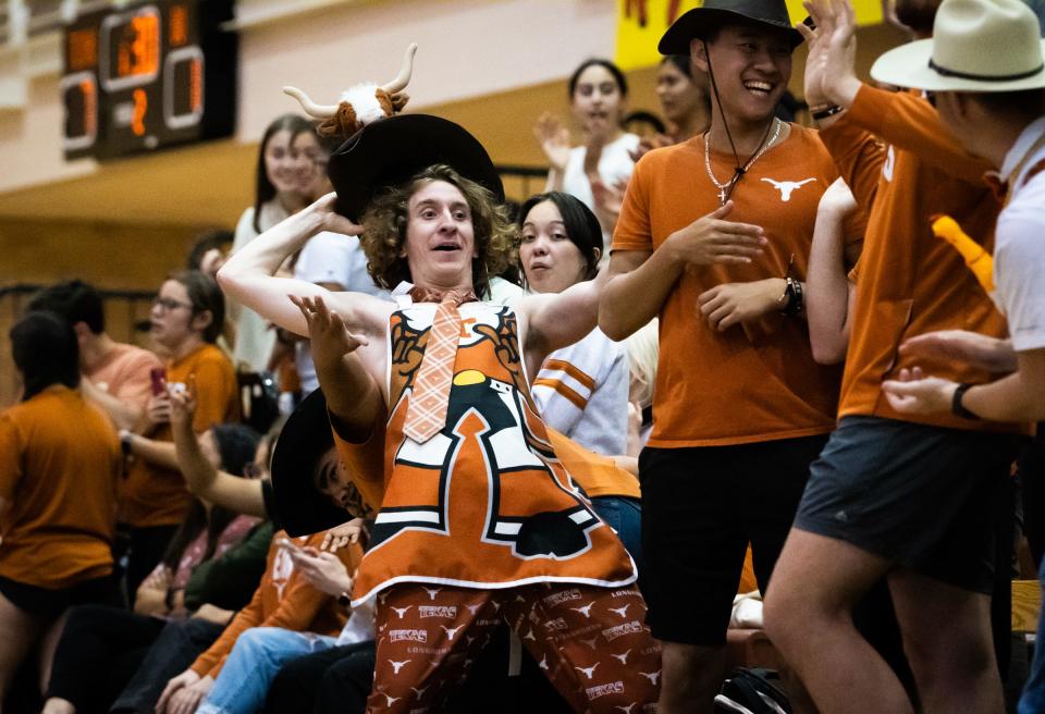 Texas fan Jack Maddox, known as "Bevo Hat Guy" on campus, celebrates a point during the Longhorns' spring match against Baylor at Gregory Gym on Wednesday. The Longhorns won four of the five sets while showcasing some new players.