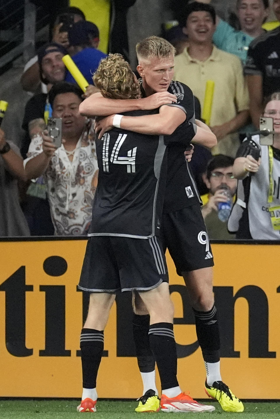 Nashville SC midfielder Jacob Shaffelburg (14) congratulates forward Sam Surridge (9) after his goal against CF Montréal during the first half of an MLS playoff soccer match Saturday, May 4, 2024, in Nashville, Tenn. (AP Photo/George Walker IV)