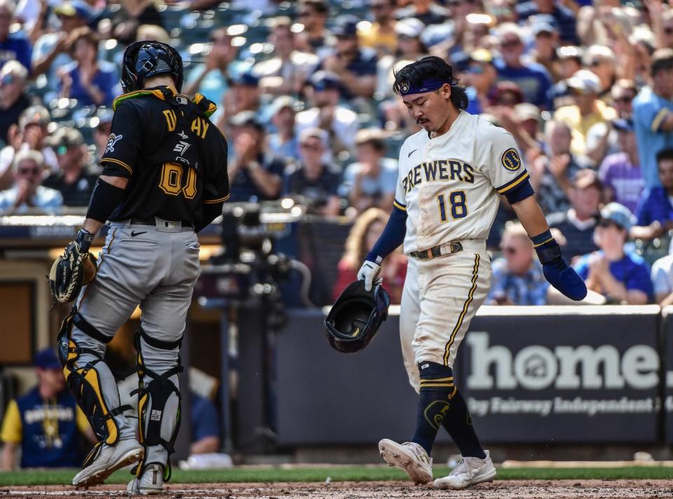Brewers first baseman Keston Hiura scores an unearned run in the sixth inning as Pirates catcher Jason Delay looks on at American Family Field on Wednesday afternoon.