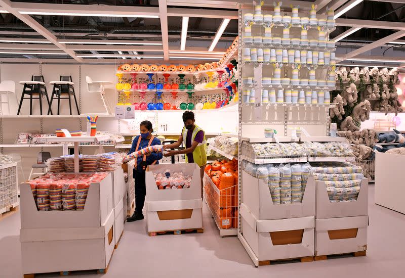 Employees arrange decorative items inside IKEA's new store in Bengaluru