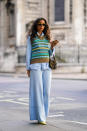 Gabriella Berdugo is seen wearing a pale blue two-set layered with a statement knit and Fendi bag. [Photo: Getty Images]