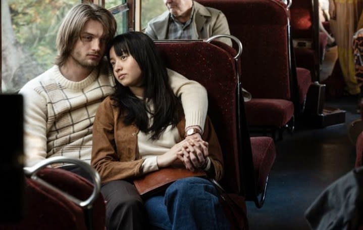 A man and a woman sit on a bus in Touch.