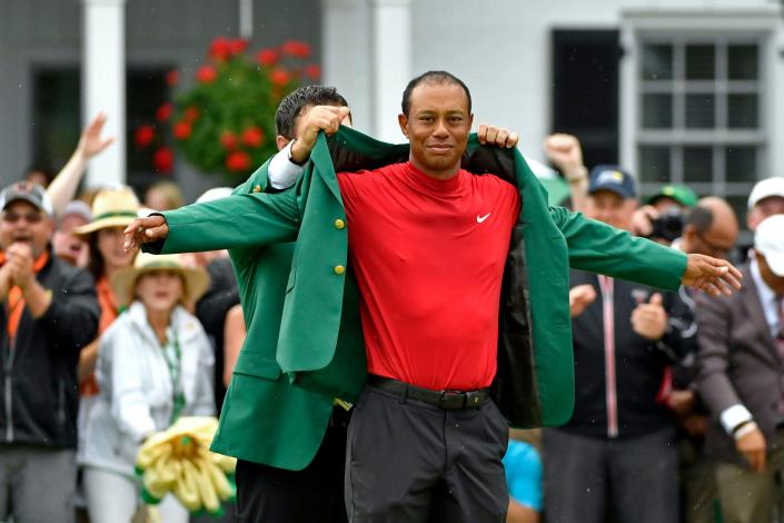 Tiger Woods is presented with the green jacket after winning the 2019 Masters at Augusta National.