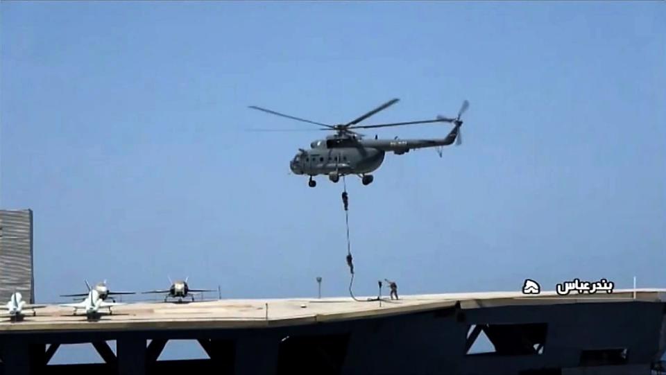 Commandos rappelled down onto the mock US aircraft carrier (IRIB NEWS AGENCY/AFP via Getty I)