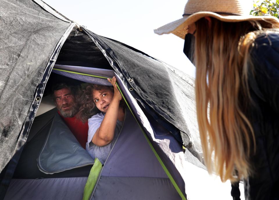 Sieglinde von Deffner checks on Michael and Tanya Myers at a tent in Van Nuys.