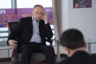 In this Friday, Jan. 17, 2014 photo made available by Presidential Press Service on Sunday, Jan. 19, 2014, Russian President Vladimir Putin listens to a translation during an interview to Russian and foreign media at the Russian Black Sea resort of Sochi, which will host Winter Olympic Games on Feb. 7, 2014. President Vladimir Putin once again has offered assurances to gays planning to attend the Sochi Olympics, but his arguments defending Russia’s ban on homosexual “propaganda” to minors show the vast gulf between how he understands the issues and how homosexuality is generally viewed in the West. In an interview with Russian and foreign television stations broadcast Sunday, Putin equated gays with pedophiles and spoke of the need for Russia to “cleanse” itself of homosexuality as part of efforts to increase the birth rate. (AP Photo/RIA Novosti, Alexei Nikolsky, Presidential Press Service)